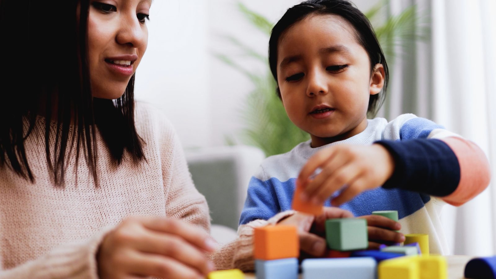 Therapist working with a child on hand skills